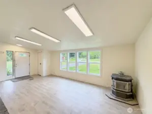 Another view of the living room with a pellet stove ready for the new buyers to hook up.