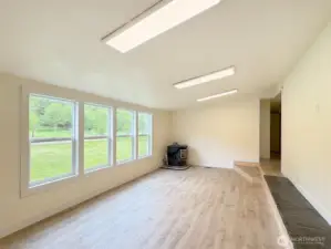 The living room from the front door, notice the step up to the hall area, or into the kitchen. Raised hearth on the right perfect for large screen TV.