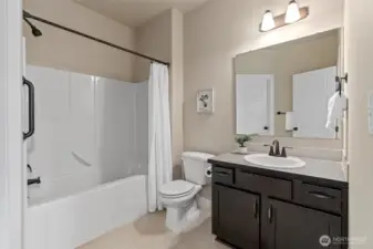 Ensuite bath located off of the ground floor bedroom with it's own walk-in closet.