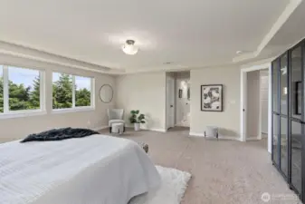 Spacious primary bedroom with stunning water views.