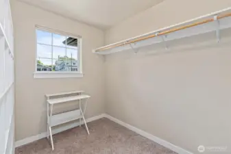 One of the two large walk-in closets located in the primary bedroom.