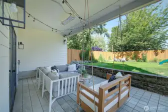 Lower level patio includes built-in heater and built-in two-person swing