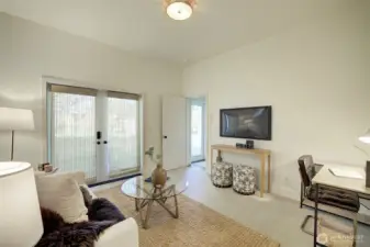 Lower level bedroom with double door entrance to heated patio