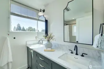 Upper level bathroom with custom cabinetry, Carrara marble tile and double sink