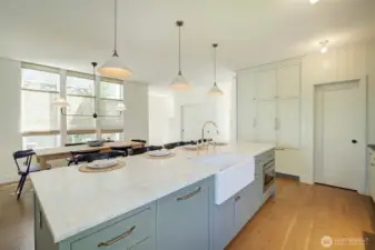 View of island shows built-in dishwasher, built-in microwave - door to the right leads to pantry