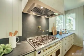 Imported Italian ILVE range, double oven, pot-filler faucet, lime wash hood, soapstone countertops and backsplash