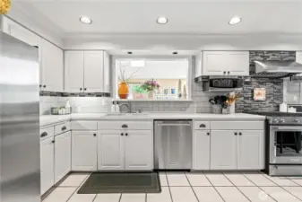 Kitchen peephole overlooks second dining room and brings in so much extra light!