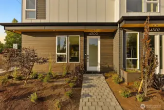 A warm welcome awaits with this thoughtfully landscaped front entry—modern lines meet lush touches in perfect harmony.