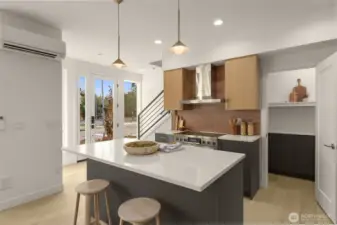 Designed for entertaining or unwinding, this open kitchen and dining area flows effortlessly into the heart of the home.