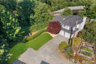 Expansive back yard w/ outdoor kitchen, multiple entertaining areas, Swim Spa & garden beds