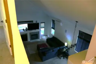 Living Room with vaulted ceiling from upstairs hallway