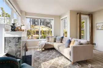 The bright and cheery interior boasts new LVP flooring, a cozy gas fireplace, and fresh paint.