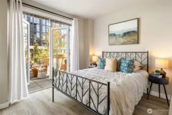 The primary bedroom looks out to the terrace so you can wake to soft morning sun and fall asleep beneath twinkling city lights.