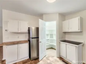 Custom shelving maximizes every inch of this pantry, offering abundant storage and easy access for all your cooking and household supplies.