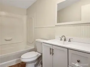 This hall bath feels bright and welcoming with its new vanity, sink and faucets.