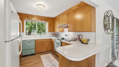 Classic mid-century kitchen with abundant cabinetry and roomy counters that make cooking simple and enjoyable.