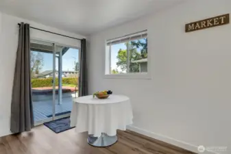 The dining room opens through a sliding glass door to the back deck, creating an effortless flow for entertaining and offering a hot tub for year-round relaxation.