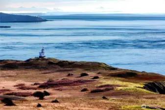 Iconic coastal lighthouse perched above the shoreline, capturing the dramatic scenery and maritime heritage of the Cape San Juan area.