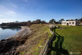 Community waterfront area featuring rocky beach access and expansive water views, emphasizing the coastal lifestyle available at Cape San Juan.