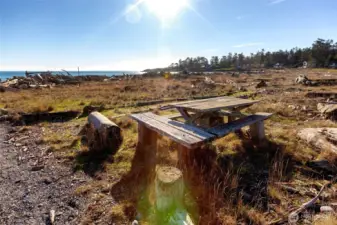 Community beach picnic area overlooking the water, ideal for enjoying sunsets, outdoor gatherings, and relaxed island living.