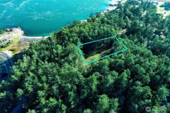 Alternate aerial perspective highlighting the buildable clearing within this San Juan Island vacant lot, showcasing privacy, natural surroundings, and proximity to the coastal bluff.