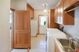 Spacious utility/laundry room with ample storage and direct access for everyday convenience.