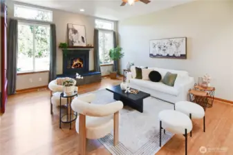 Inviting living room with large windows, cozy fireplace, and open layout ideal for gathering.