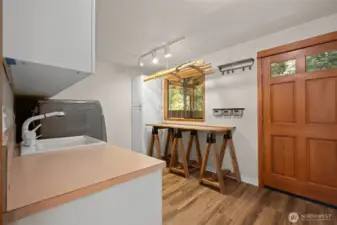 spacious laundry/mud room off carport