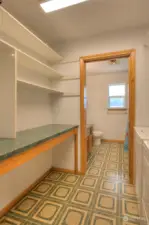 Upstairs laundry room, leading to full bath