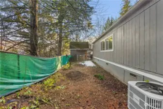 Fenced backyard and heat pump