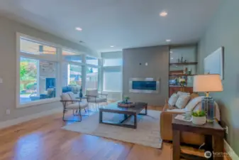 Expansive windows flood the great room with light and views to the backyard oasis
