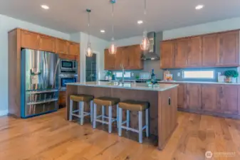Gourmet kitchen with Quartz countertops and 5' fridge/freezer and gas range