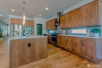 Kitchen features wine fridge, and large walk in pantry