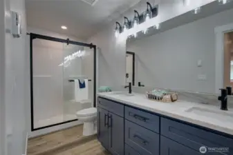 Primary bathroom with double sinks and shower