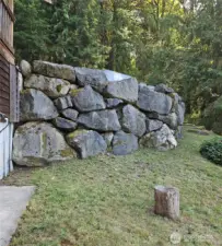 Rock wall by barn and driveway