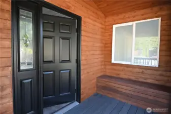 A covered porch with built-in bench seating welcomes you home!