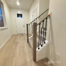 Lovely entry with modern/open stair rail.