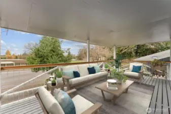 Covered balcony on the split-level portion of home. Christensen Elementary School is across the street. Huge playfield to the right of the school.