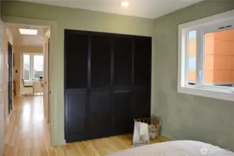 Bedroom closet and hallway back to the bathroom and living room.