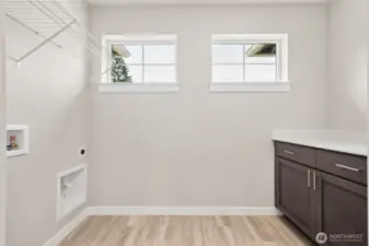 Laundry room has storage galore! Photo's are for representational purposes only. Colors and finishes may differ.