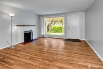 Large picture window brings in the light and provides views of the yard and flowering wisteria.