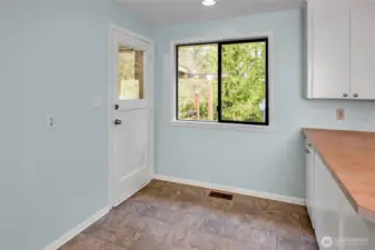 From the kitchen dining space the door heads out to the covered patio and backyard.