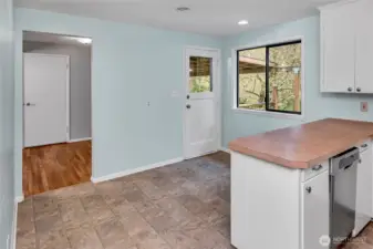 Looking through the threshold towards the dining room from the kitchen.