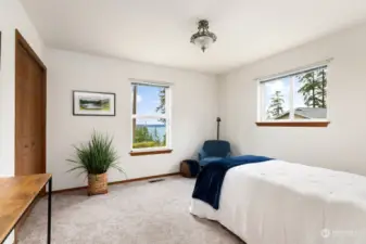 The first bedroom to the left takes in water and mountain views.