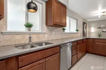 The extra-long counter space is a dream for meal prep or entertaining, while updated pendant lighting adds a modern touch. The dishwasher is only 1 year old too! Thoughtfully designed windows keep things bright while maintaining your privacy from the lakeside neighbor.