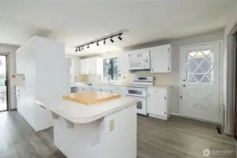 New flooring throughout kitchen and dining room.