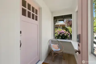 This cute enclosed porch offers a perfect sunny spot for morning coffee.