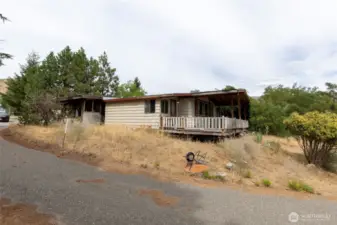 side showing carport and deck