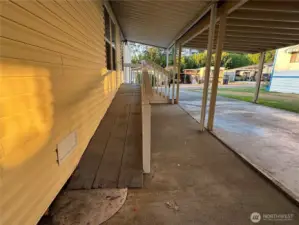 Nice covered parking to a ramp to the front door.
