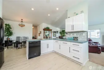 The kitchen has several workstations with plenty of cabinets!